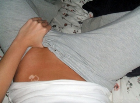 Blonde amateur removes her pants while taking self shots