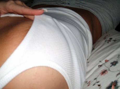 Blonde amateur removes her pants while taking self shots