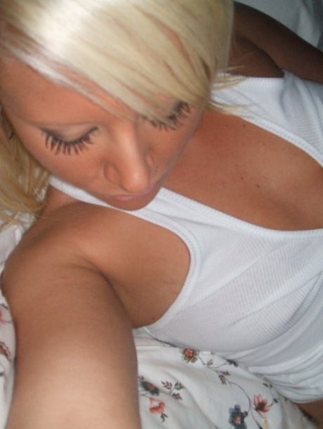 Blonde amateur removes her pants while taking self shots