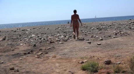 Caucasian female with short hair Chloe Lamour squats for a piss in her bikini
