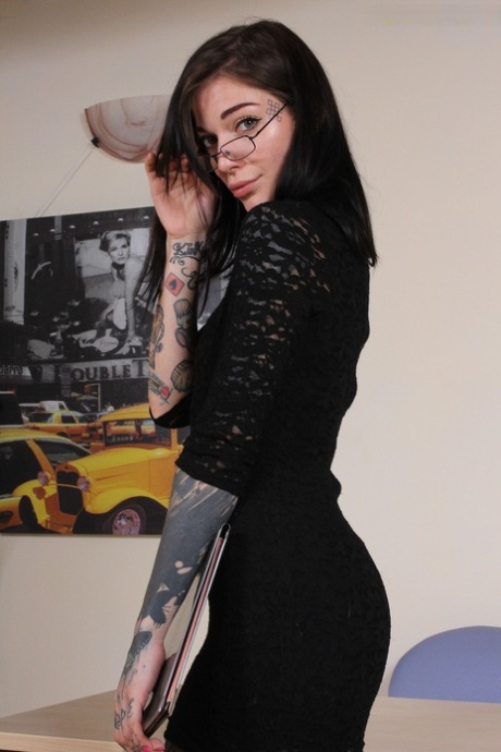 Tattooed girl Refen removes her red soled heels while wearing pantyhose