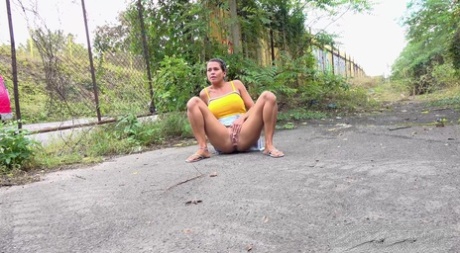 Short taken girl Chloe Lamour takes a badly needed piss on a patch of pavement