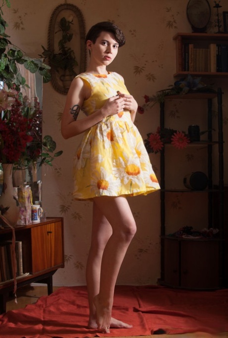 Young girl with short hair and perky tits gets naked in a confident manner