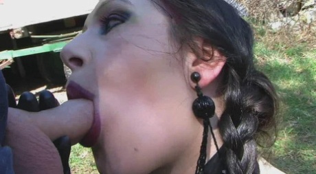 Thick goth woman Lady Angelina plays with her pigtails during an outdoor BJ