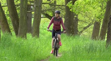 Solo girl Antonia Sainz squats for a pee while biking on a path in the woods