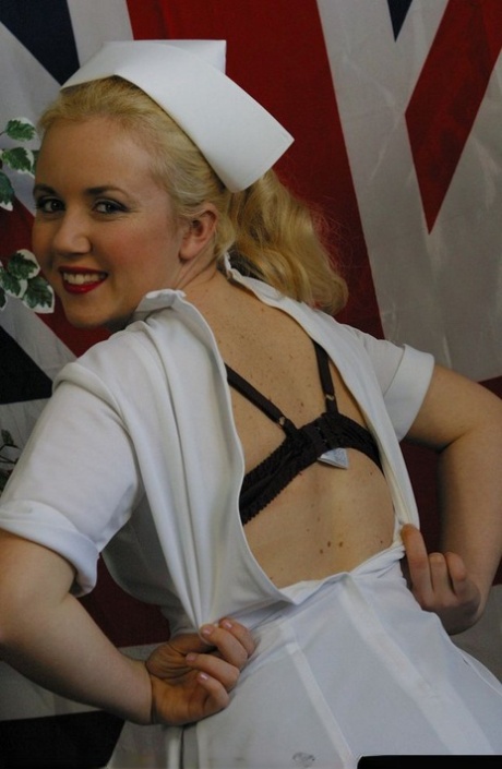 Blonde British nurse exposes her tits and snatch in tan nylons