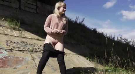 Blonde girl Nastya pulls down her pants for a badly needed pee in the outdoors