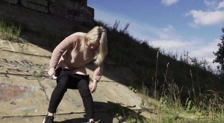 Blonde girl Nastya pulls down her pants for a badly needed pee in the outdoors