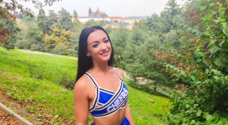 Brunette cheerleader has sex on a bed with a large white cock