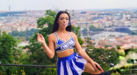 Brunette cheerleader has sex on a bed with a large white cock