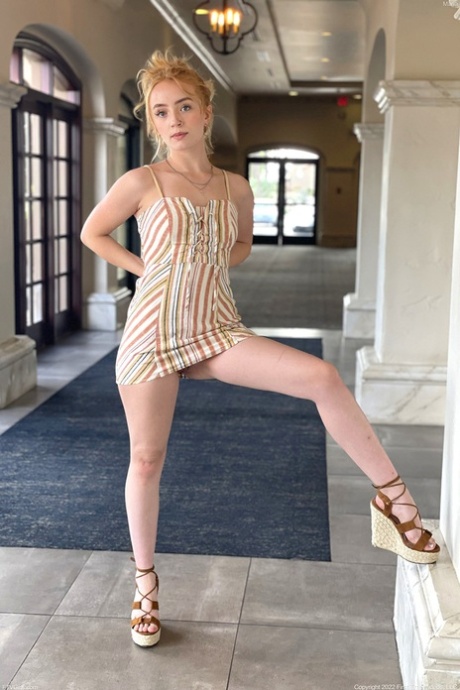 Pretty redhead Maria models a short dress while wearing no underwear