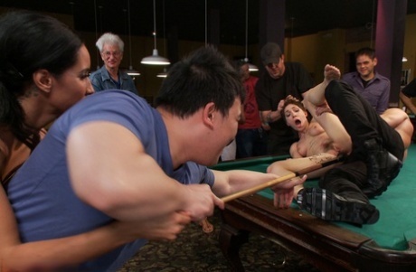 Naked brunette is restrained and penetrated inside a billiard club