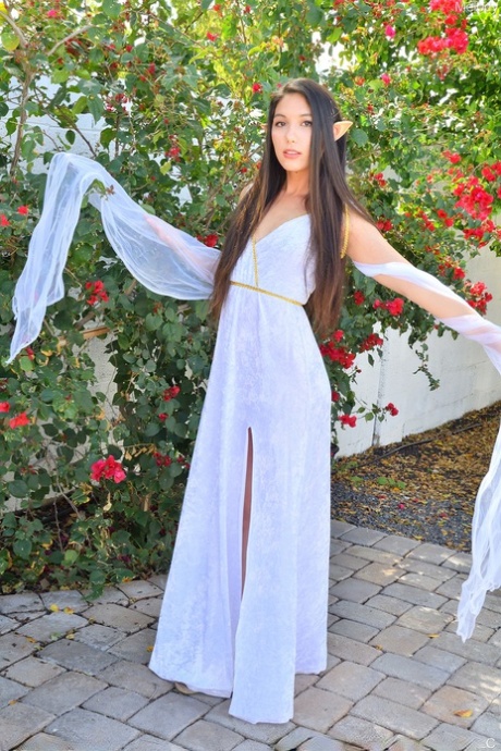Brunette amateur Melody rides a dildo atop garden statuary