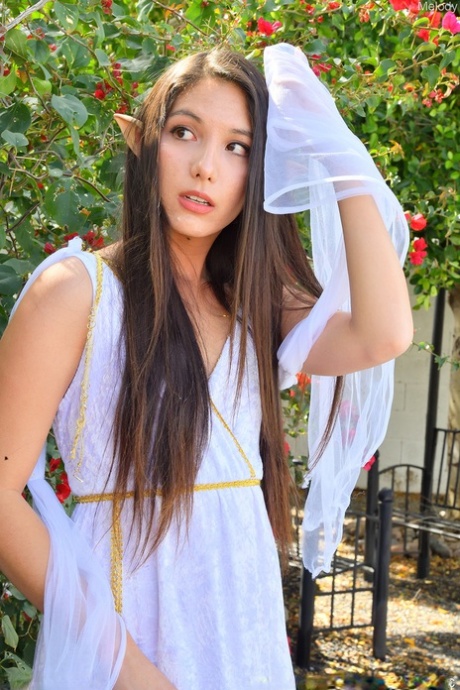 Brunette amateur Melody rides a dildo atop garden statuary