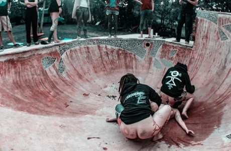Alternative individuals have sex at a skate park while being pissed on