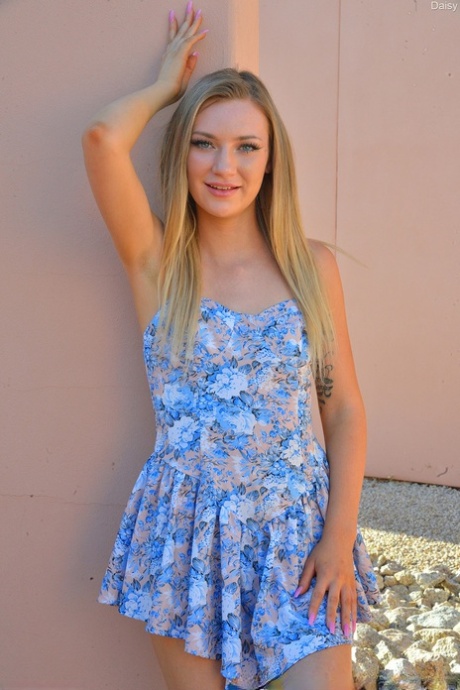 Natural blonde Daisy flashes her pussy outdoors with no panties on
