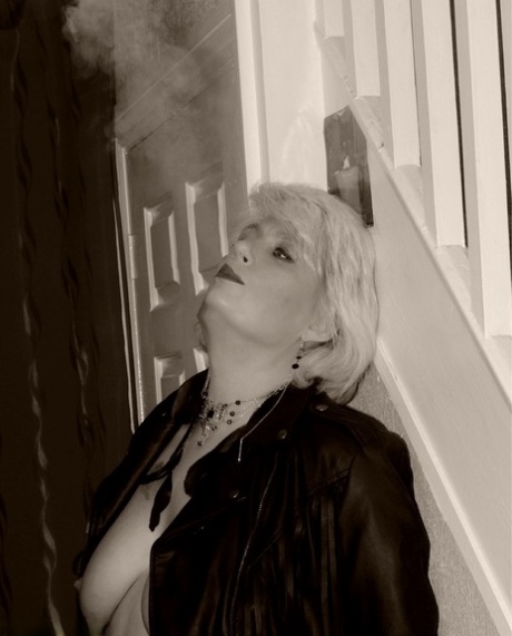 Older blonde Dimonty shows her tits and snatch while smoking a cigarette