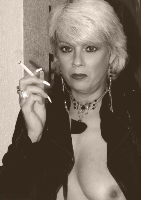 Older blonde Dimonty shows her tits and snatch while smoking a cigarette