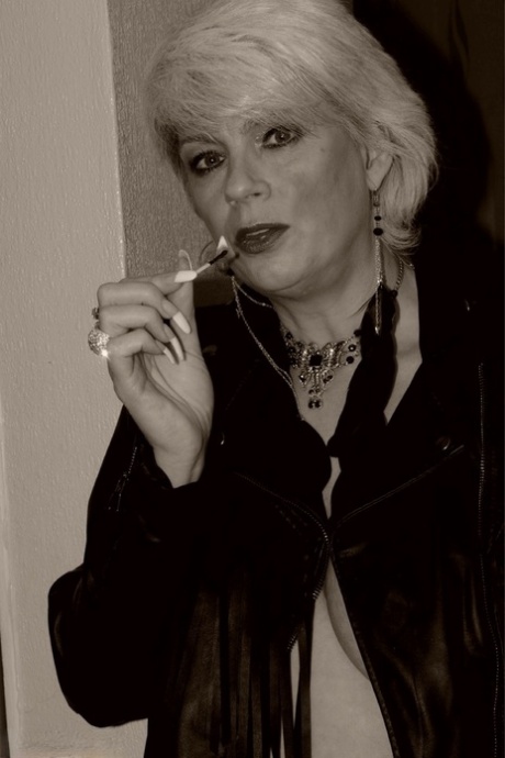 Older blonde Dimonty shows her tits and snatch while smoking a cigarette