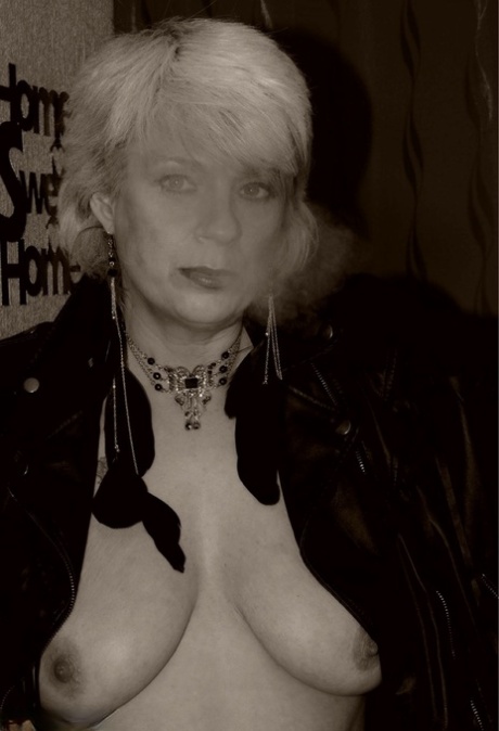 Older blonde Dimonty shows her tits and snatch while smoking a cigarette