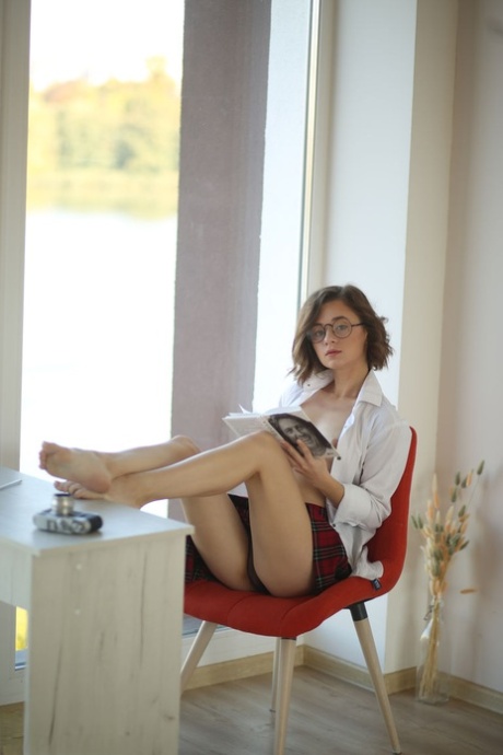 First timer Katrina peers over her glasses prior to getting bare naked