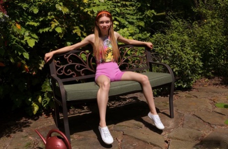 Redheaded teen Jessica Marie pees on a patio bench in white running shoes