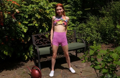 Redheaded teen Jessica Marie pees on a patio bench in white running shoes