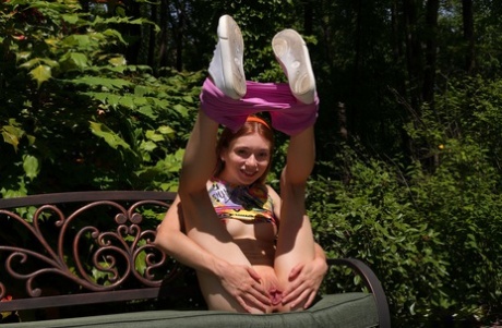 Redheaded teen Jessica Marie pees on a patio bench in white running shoes