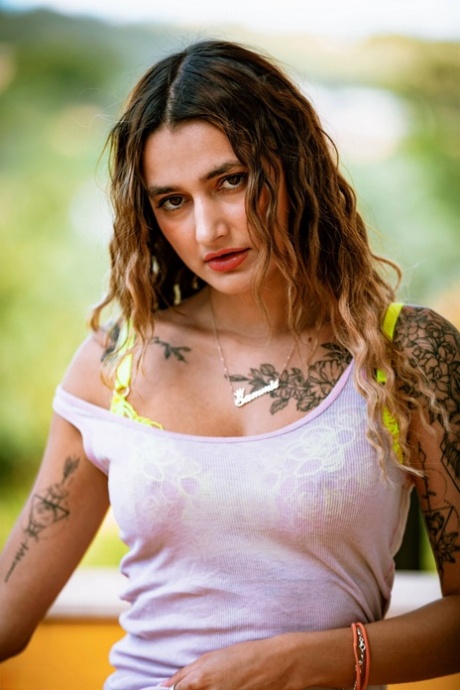 Tattooed chick Seline P strips down to a thong and socks on a balcony