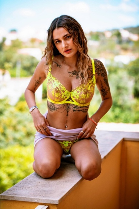 Tattooed chick Seline P strips down to a thong and socks on a balcony