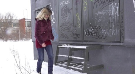 Caucasian girl Jessy shows her bare ass while peeing on snow-covered ground