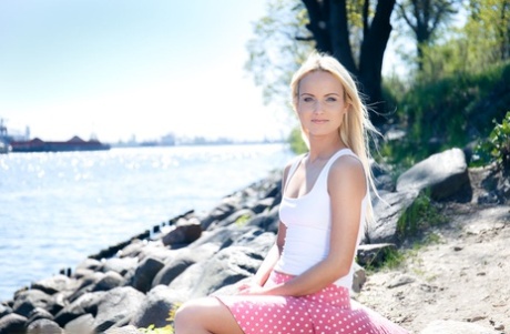 Blonde teen Sophia Sonne gets naked on a rocky shoreline in running shoes