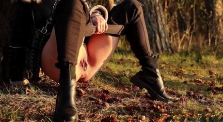 Sexy girl Katy Dee leans back against a tree to take a badly needed pee