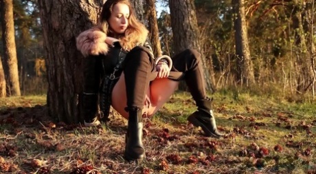 Sexy girl Katy Dee leans back against a tree to take a badly needed pee