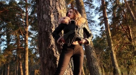 Sexy girl Katy Dee leans back against a tree to take a badly needed pee