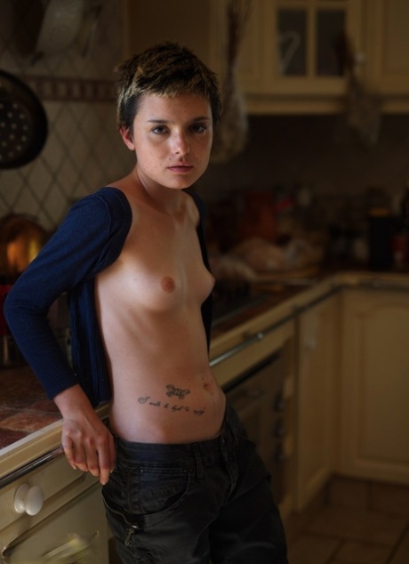 Skinny girl with short hair Caterina Correia shows her naked body in a kitchen