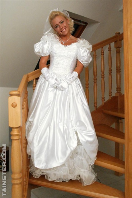 New bride dressed in her wedding dress plays water sport games at reception
