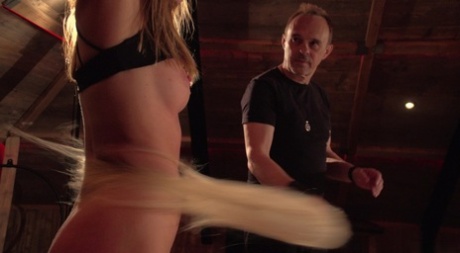 Restrained blonde Julia Rain is worked over by a sadist before giving a BJ