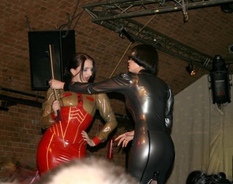 Fire performers in latex enhance the mood at a fetish convention