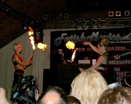 Fire performers in latex enhance the mood at a fetish convention