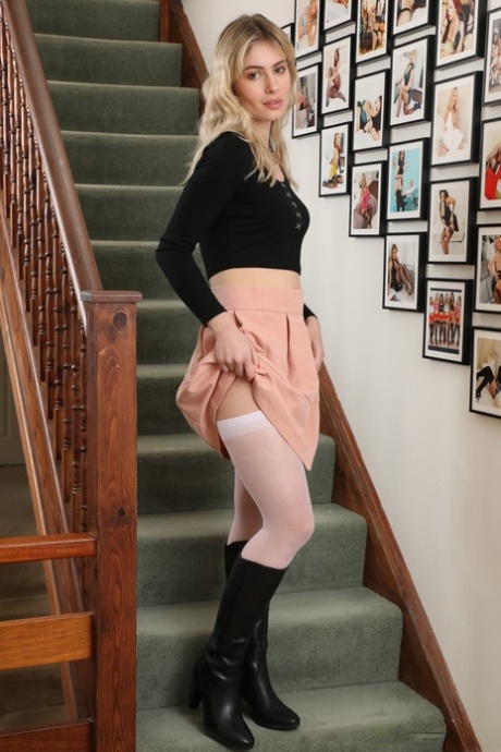 Beautiful blonde Pippa Doll strips to a garter belt and white nylons