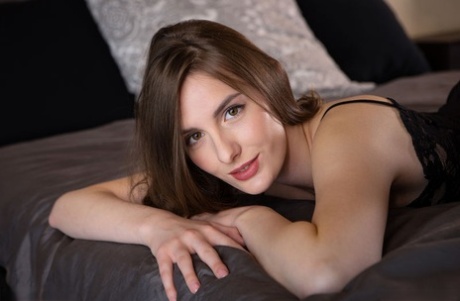 Nice teen sets her great body free of clothing on top of a bed
