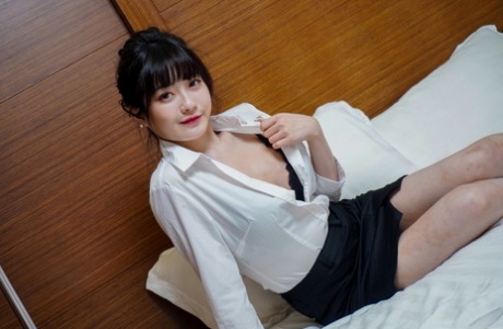 Chinese girl Huang Ying gives a blowjob and fucks before posing in work attire