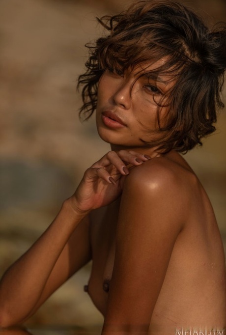 Hot Thai teen Rosah takes off her bikini to go nude on a boulder