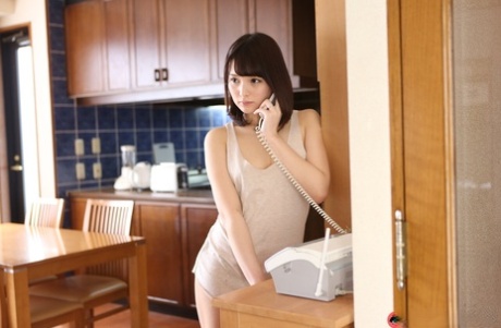 Japanese beauty Mihono shows her natural tits while on the telephone