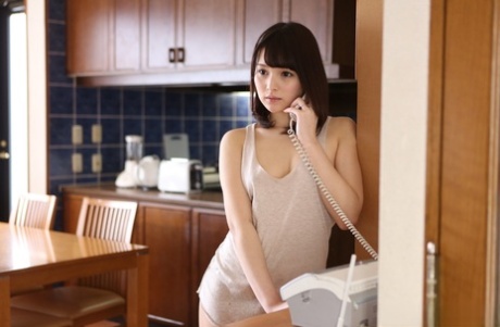 Japanese beauty Mihono shows her natural tits while on the telephone