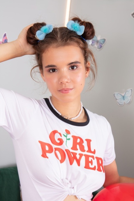 Adorable teen Midia holds a couple of balloons before getting naked