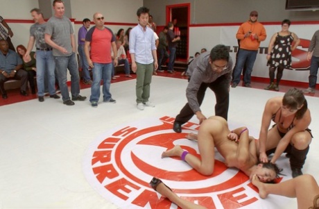 Petite brunette is forced into humiliating public sex at a wrestling match