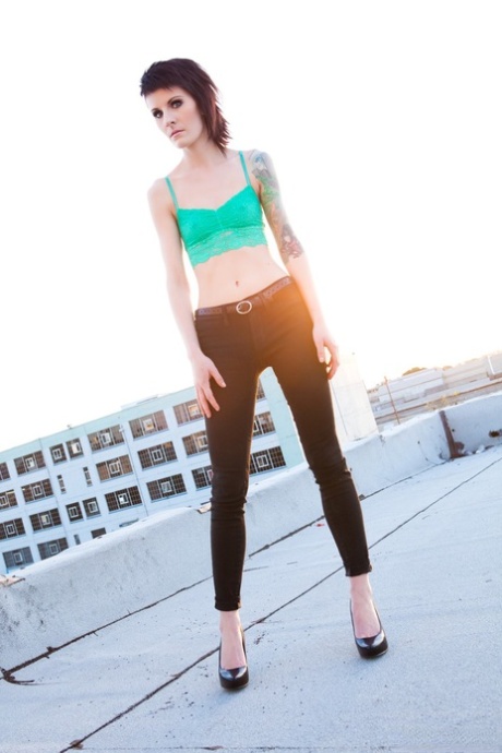 Skinny alt babe with tattooed body exposing tiny tits outdoors on rooftop