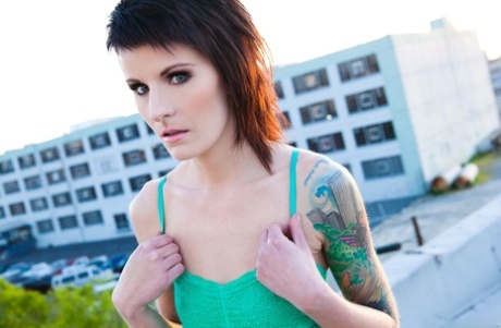 Skinny alt babe with tattooed body exposing tiny tits outdoors on rooftop